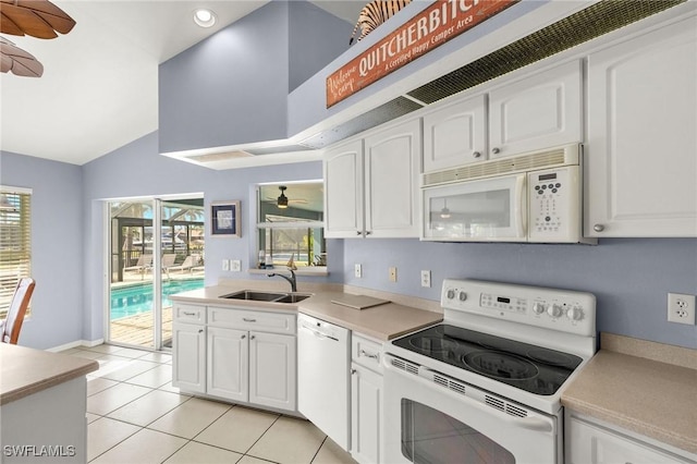 kitchen featuring light tile patterned floors, sink, white appliances, and white cabinets