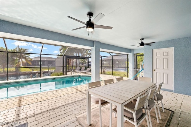 view of pool featuring a lanai, ceiling fan, and a patio area