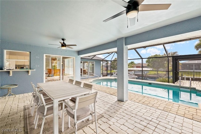 view of pool with a lanai, ceiling fan, and a patio area