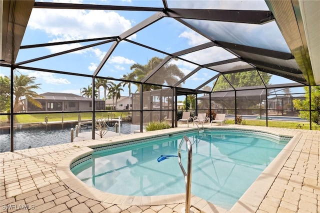 view of swimming pool featuring a lanai and a patio area