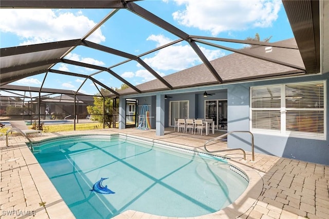 view of swimming pool featuring a lanai, ceiling fan, and a patio