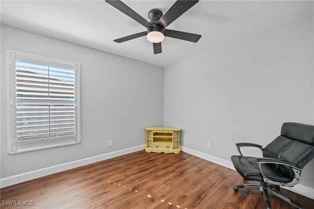 office space with hardwood / wood-style flooring, a ceiling fan, and baseboards