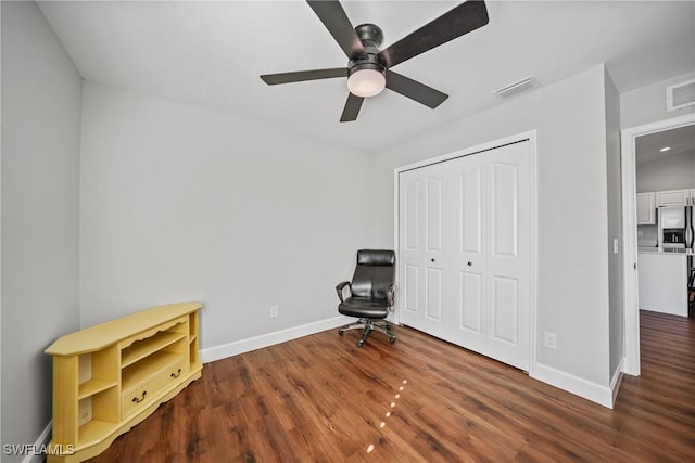 unfurnished room featuring a ceiling fan, wood finished floors, visible vents, and baseboards