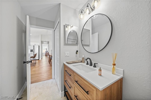 bathroom with vanity and baseboards