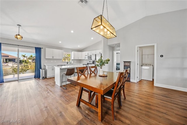 dining space featuring visible vents, baseboards, recessed lighting, wood finished floors, and washer / clothes dryer