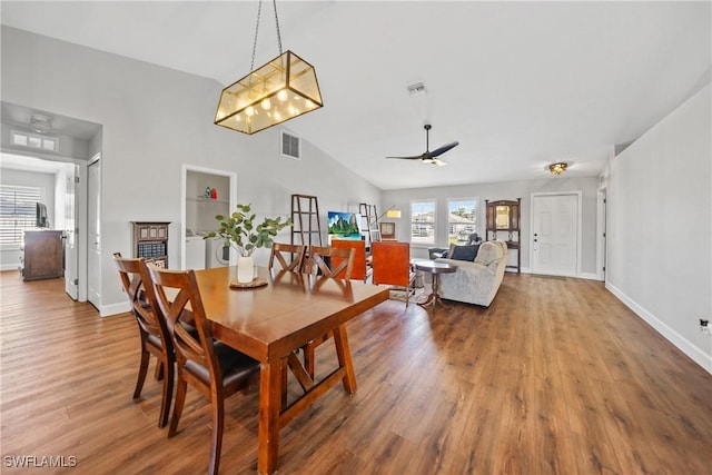 dining room featuring visible vents, independent washer and dryer, wood finished floors, and vaulted ceiling