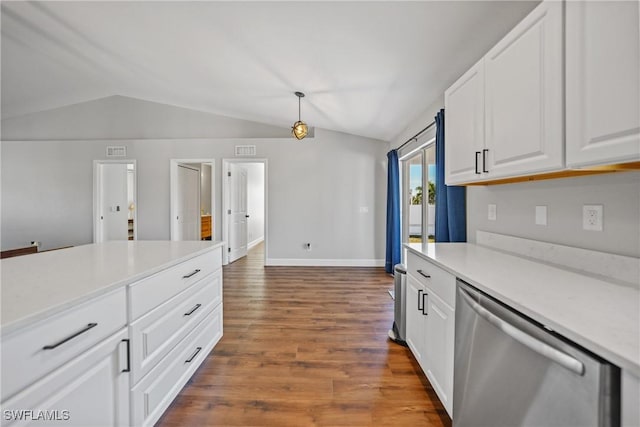 kitchen with wood finished floors, vaulted ceiling, white cabinets, light countertops, and stainless steel dishwasher