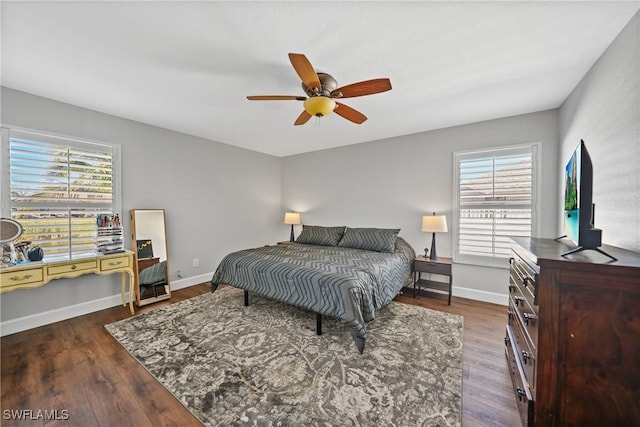 bedroom with ceiling fan, baseboards, and wood finished floors