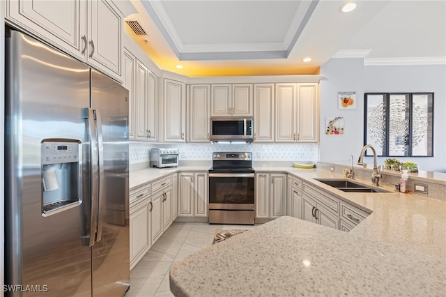 kitchen with light stone countertops, sink, stainless steel appliances, kitchen peninsula, and crown molding