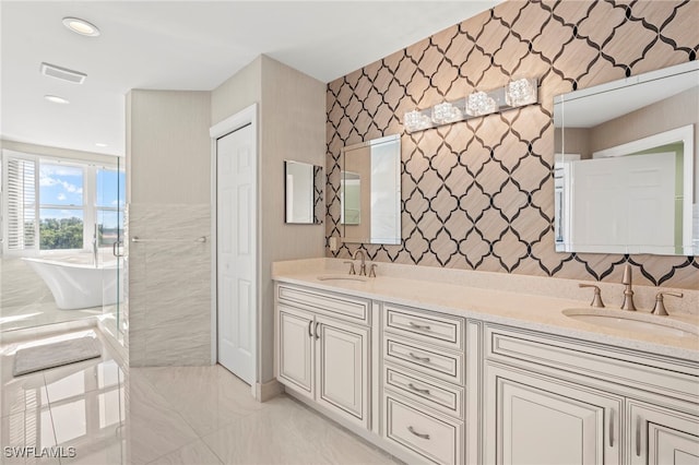 bathroom with a washtub and vanity