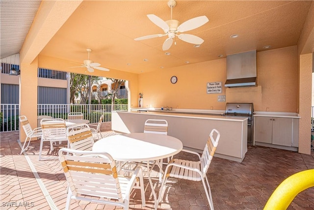 view of patio featuring an outdoor kitchen and ceiling fan