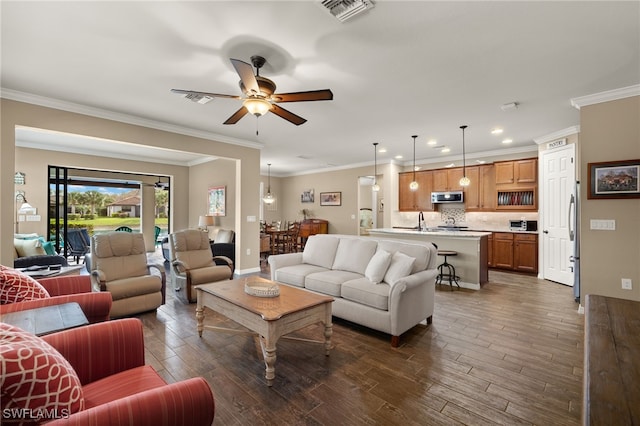 living room with dark hardwood / wood-style flooring, ceiling fan, and ornamental molding