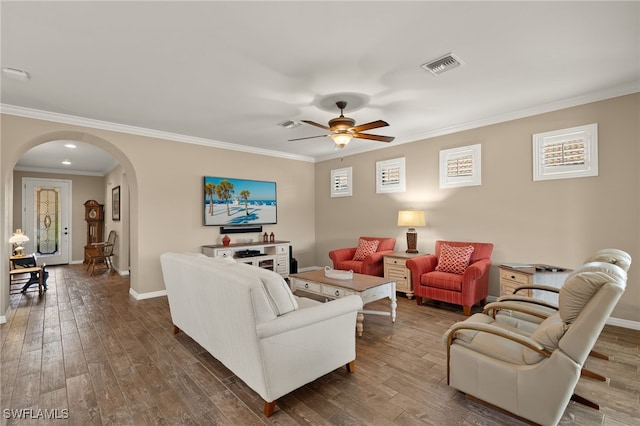 living room featuring dark hardwood / wood-style floors, ceiling fan, and crown molding