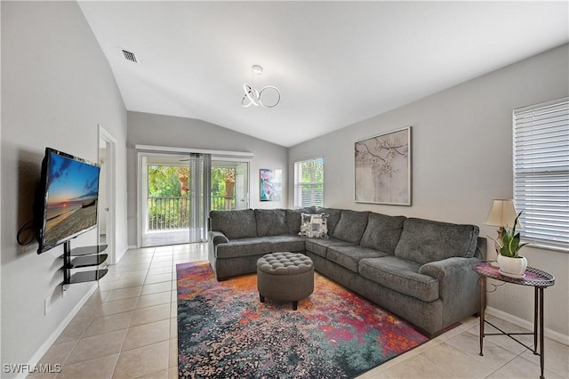 living room featuring lofted ceiling and light tile patterned floors