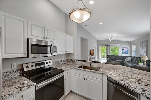 kitchen with white cabinetry, sink, stainless steel appliances, and vaulted ceiling