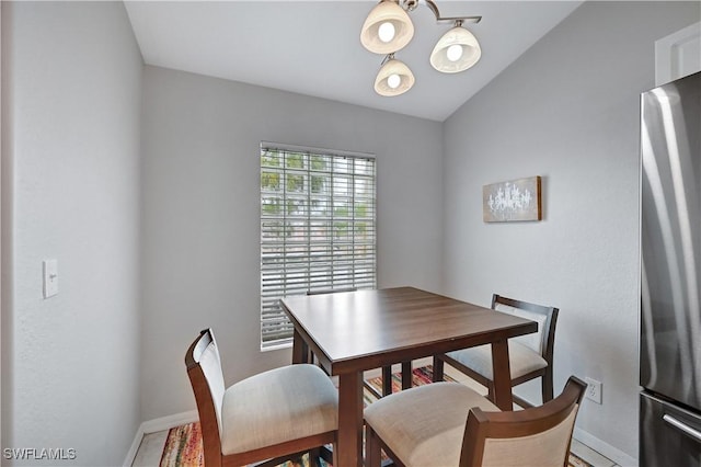 dining room featuring vaulted ceiling