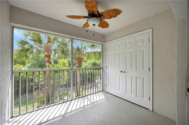 unfurnished sunroom with ceiling fan and a healthy amount of sunlight