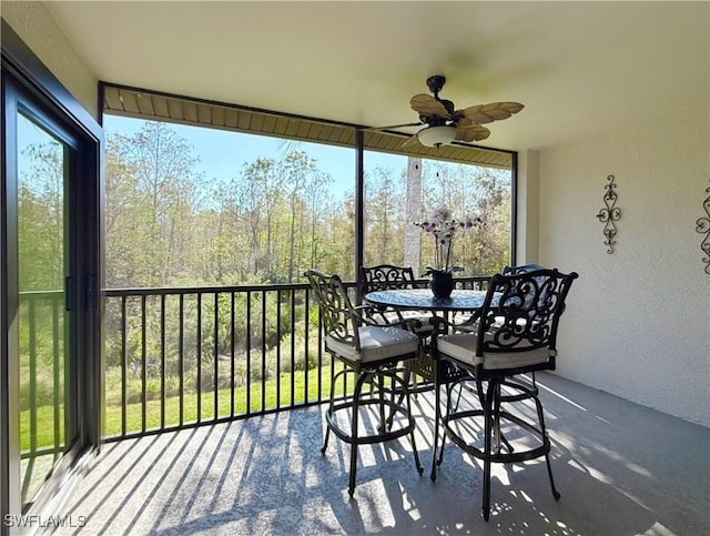 sunroom / solarium featuring ceiling fan