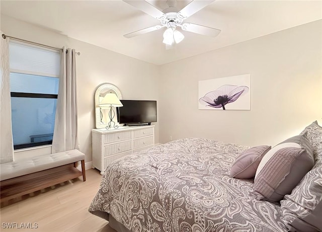 bedroom with light hardwood / wood-style floors and ceiling fan