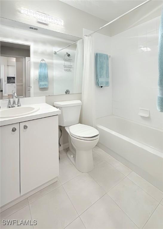 full bathroom featuring tile patterned floors, shower / bath combo, toilet, and vanity