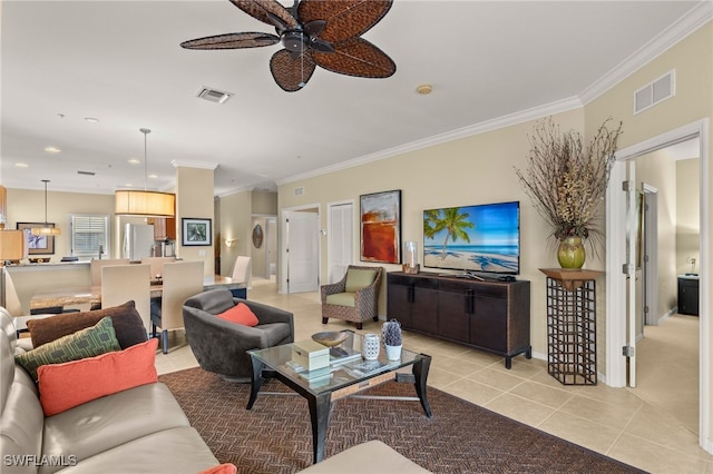 tiled living room with ceiling fan and crown molding