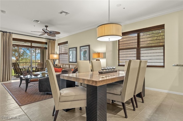 dining space featuring ceiling fan and ornamental molding