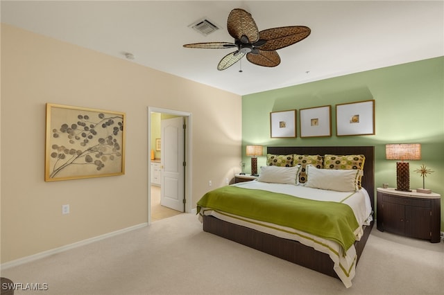 carpeted bedroom with ceiling fan and ensuite bathroom