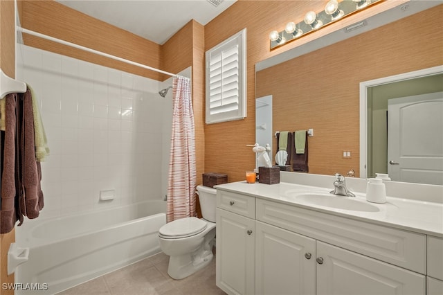 full bathroom featuring toilet, vanity, tile patterned flooring, and shower / bath combo