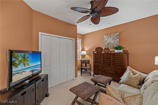 carpeted living room with ceiling fan