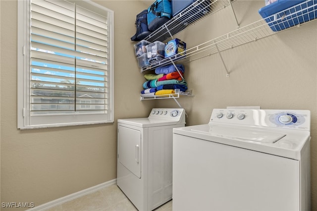 laundry area featuring separate washer and dryer and light tile patterned floors