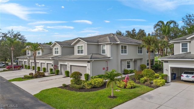 view of front of home with a front yard and a garage