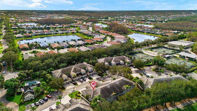 birds eye view of property with a water view