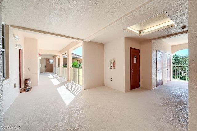 unfurnished room with a textured ceiling