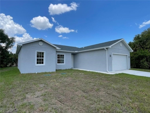 view of front of house with a garage and a front lawn