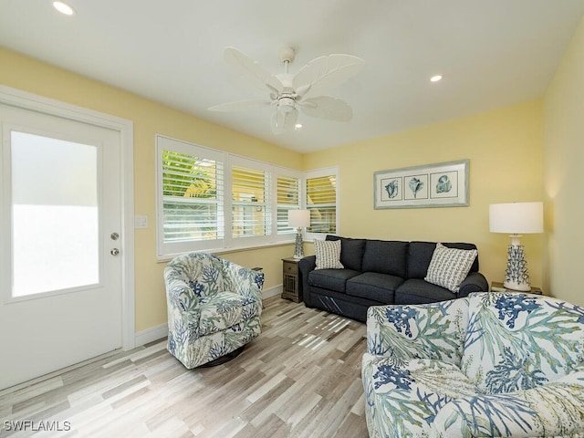 living room featuring ceiling fan and light wood-type flooring