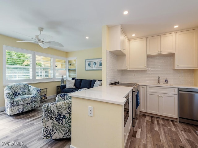 kitchen featuring white cabinets, sink, ceiling fan, appliances with stainless steel finishes, and kitchen peninsula