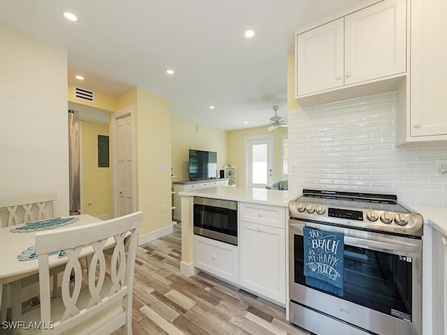 kitchen with white cabinetry, built in microwave, ceiling fan, backsplash, and stainless steel electric range