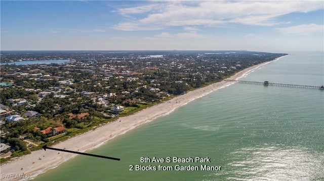 birds eye view of property with a beach view and a water view