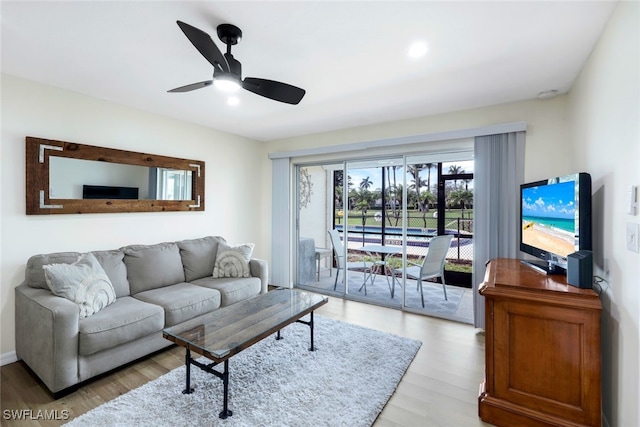 living room featuring ceiling fan and light wood-type flooring