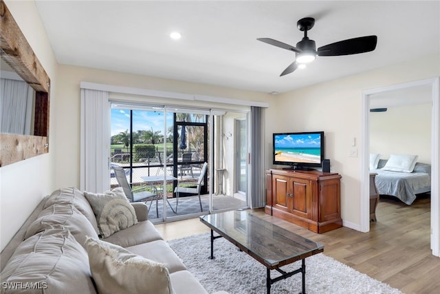 living room featuring light hardwood / wood-style floors and ceiling fan