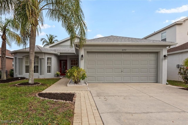 ranch-style home featuring a garage and a front lawn