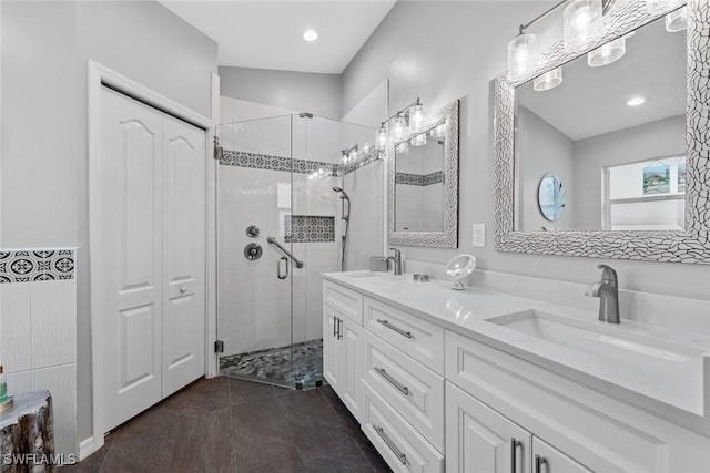 bathroom with a shower with door and vanity