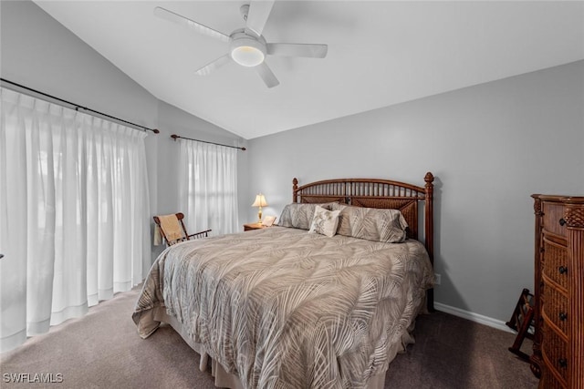 bedroom with ceiling fan, vaulted ceiling, and dark colored carpet