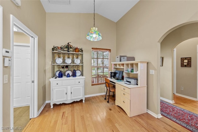 office space featuring light hardwood / wood-style floors and high vaulted ceiling