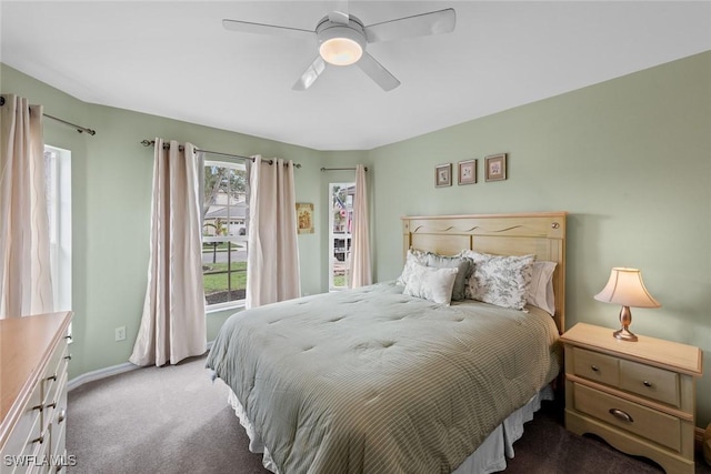 bedroom with dark colored carpet and ceiling fan