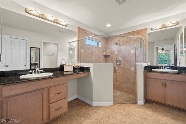 bathroom featuring tile patterned flooring, vanity, a shower with door, and ceiling fan