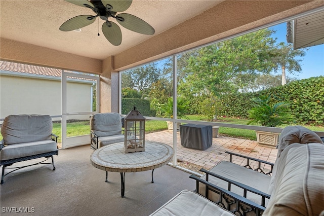 sunroom featuring ceiling fan