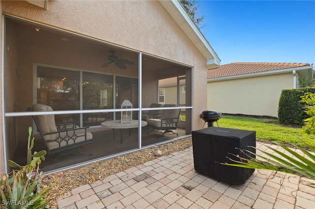 view of patio / terrace featuring a sunroom