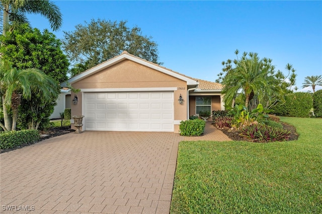 single story home with a garage and a front lawn