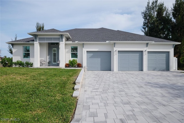 view of front of home with a garage and a front yard